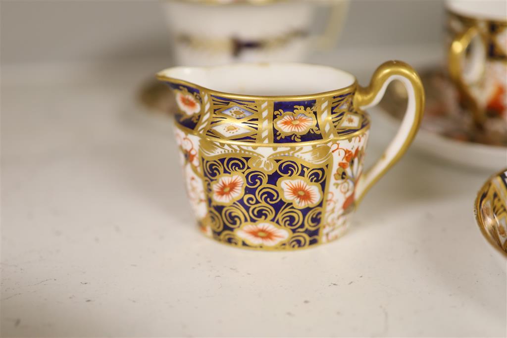 Six Royal Crown Derby coffee cups and saucers and teapot and stand